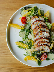 Image of portion of meal with meat and vegetables. Healthy portion of meal with pepper, lettuce, tomatoes and onion