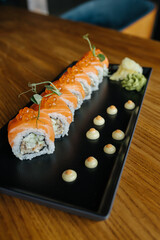 Image of sushi roll. Philadelphia roll with caviar and wasabi. Asian cuisine. Traditional japanese roll