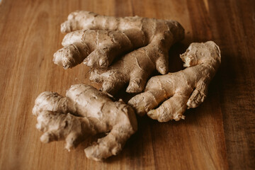 Ginger root on wooden background close up view.	