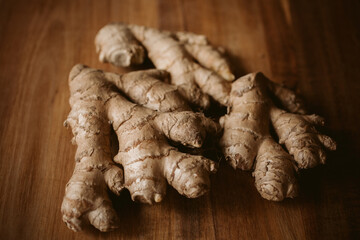 Ginger root on wooden background close up view.	