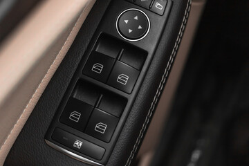 Window buttons inside luxury car. Automatic power controlling system close-up view