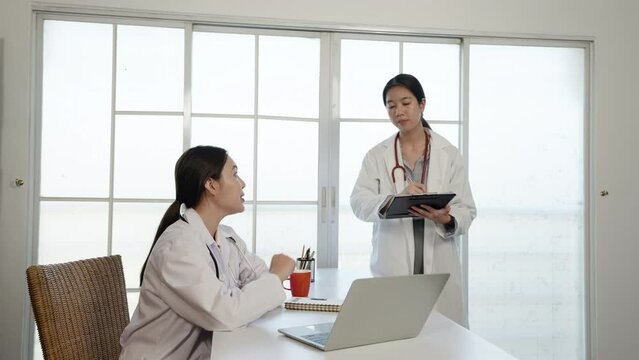 4k, an Asian female medical student wearing a white shirt  ask for advice. about the sickness of the patient and the doctor's teacher in the office of the hospital