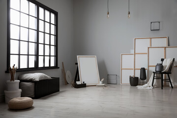 Stylish artist's studio interior with canvas and brushes