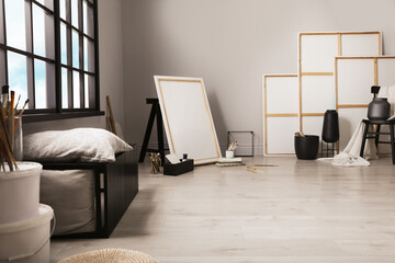 Stylish artist's studio interior with canvas and brushes