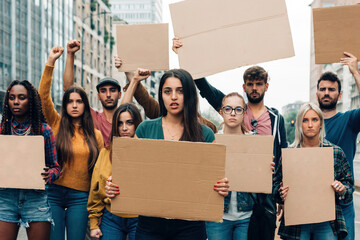 Young protestors strike with blank banners - freedom movement gender equality social issues green...
