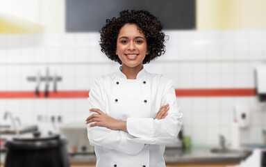 cooking, culinary and people concept - happy smiling female chef in white jacket over restaurant...