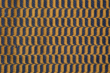 fabric in mustard color with geometric patterns. mustard knitted texture, background knitted...