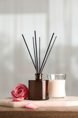 Composition with aromatic reed air freshener on wooden table