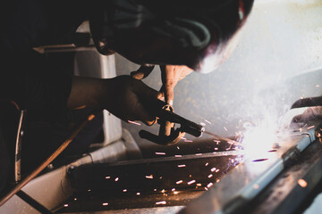 welder, welding automotive part in a car factory