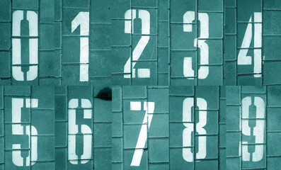 Numbers from zero to nine on pavement in cyan tone.
