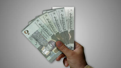 Oman Rial growing pile of money in hand concept 3d illustration - obrazy, fototapety, plakaty