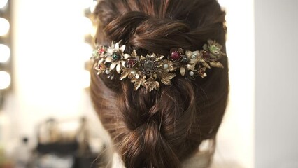 Finished stylish hairstyle with elegant hair accessories.