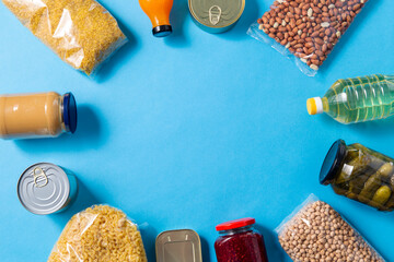 eating, charity and donation concept - close up of different packed food on blue background