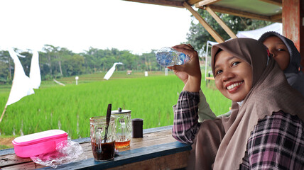 woman enjoying the view of fresh green rice