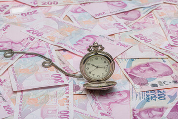 Turkish lira 200 TL counting and calculation. Hour and turkish liras bills, close up , shallow dof.