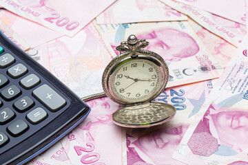 Turkish lira 200 TL counting and calculation. Hour and turkish liras bills, close up , shallow dof.