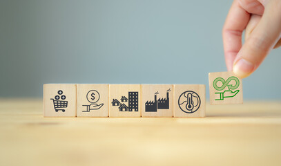 Circular economy concept. Business and environment sustainable. Climate changing problem solving goal..Putting smart flat wooden cube with sustainability and pollution sources icon on grey background.