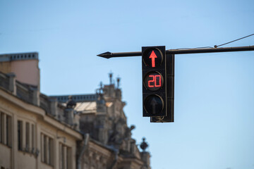 Traffic light with a burning red arrow straight ahead and a timer
