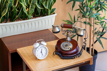 Retro telephone and alarm clock in the interior