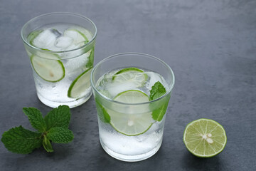 Detox water infused with lime and mint for health. Space for text. 
