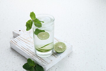 Detox water infused with lime and mint for health. Space for text. 
