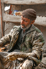 Fototapeta premium old labor worker is tired after hard work he smoking