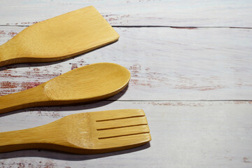 Wooden utensils on white rustic boards.