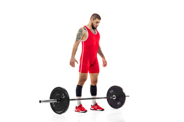 Fototapeta na wymiar Full length portrait of man in red sportswear exercising with a weight isolated on white background. Sport, weightlifting, power, achievements concept