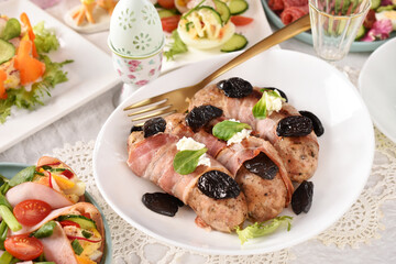 Easter grilled white sausage wrapped in bacon with prune and horseradish