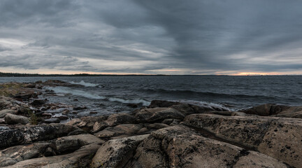 Fototapeta na wymiar Dark clouds and wild rocks at the coastline of the Baltic Sea