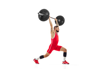 Full length portrait of man in red sportswear exercising with a weight isolated on white...