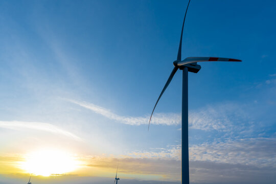 Wind turbines at sunrise in the morning. Alternative eco-friendly energy sources. . 