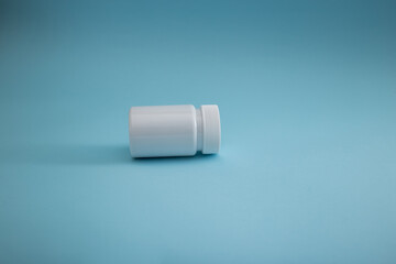 Medical packaging of pills on a blue background, a cure for the disease