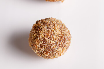 Beautiful candy truffle on a white plate on a black background