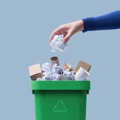 Woman putting paper in the waste bin