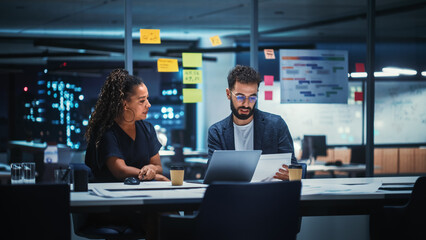 Businesspeople in Modern Office: Business Meeting of Two Managers. Female CEO and Marketing Director Talk, Brainstorm Corporate Strategy, Implementing Marketing and Financial Plans. Evening Time.