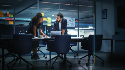 Businesspeople in Modern Office: Business Meeting of Two Managers. Female CEO and Marketing Director Talk, Brainstorm Corporate Strategy, Implementing Marketing and Financial Plans. Evening Time.