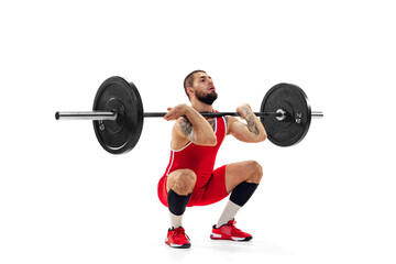 Full length portrait of man in red sportswear exercising with a weight isolated on white background. Sport, weightlifting, power, achievements concept