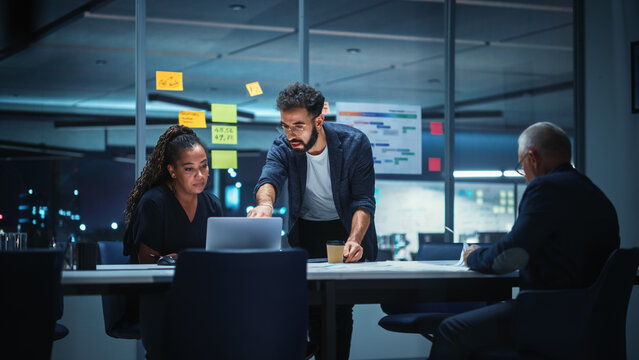 Office Conference Room Meeting: Diverse Team of Top Managers Talk, Brainstorm, Use Digital Tablet. Business Partners Discuss Financial Reports, Plan Investment Strategy. Team of Three