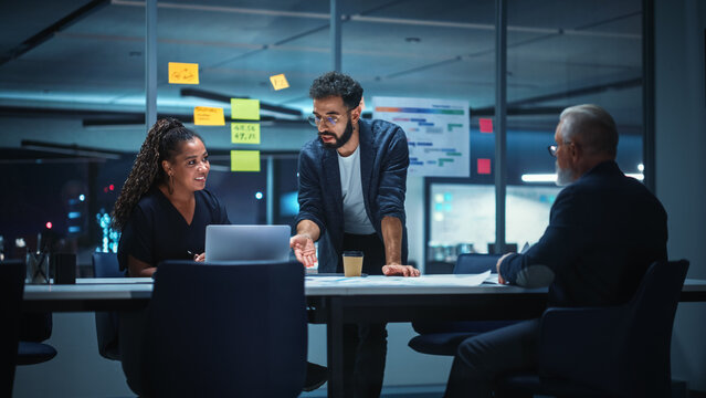 Office Conference Room Meeting: Diverse Team of Top Managers Talk, Brainstorm, Use Digital Tablet. Business Partners Discuss Financial Reports, Plan Investment Strategy. Team of Three