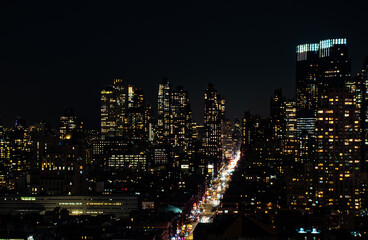 A shot of Manhattan New York citiscape skyline at night. The shot was taken on 42nd St looking into the skyscrapers lit up with their internal lights