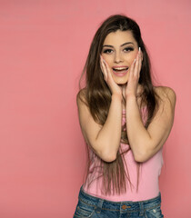 An attractive young happy woman in summer shirt. Fashion look on a pink