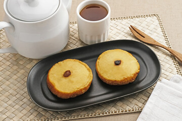 Kue Lumpur or Mud Cake, Indonesian traditional snack made from potatoes, flour, eggs and coconut milk topped with raisins. Selected focus.
