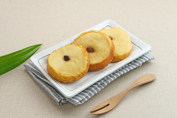 Kue Lumpur or Mud Cake, Indonesian traditional snack made from potatoes, flour, eggs and coconut milk topped with raisins. Selected focus.
