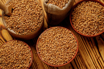 Pearl barley groats in bowls and bags on a wooden background. High quality photo