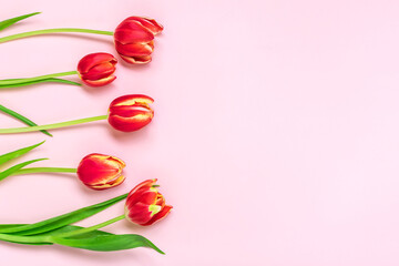 Bouquet of red tulips on pink background Top view Flat lay Holiday greeting card Happy moter's day, 8 March, Valentine's day, Easter concept Copy space Mock up