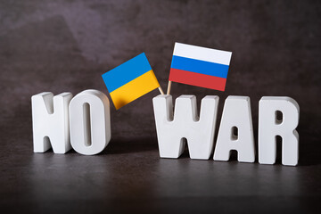 The inscription No to war in three-dimensional letters with the flags of Ukraine and Russia