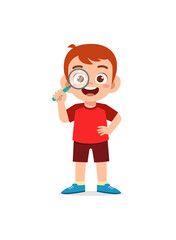 little boy standing and holding magnifying glass