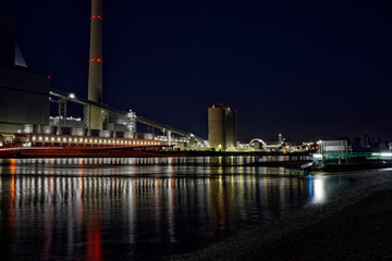 Fototapeta na wymiar Coal power plant, large power plant at night with reflection in the Rhine.