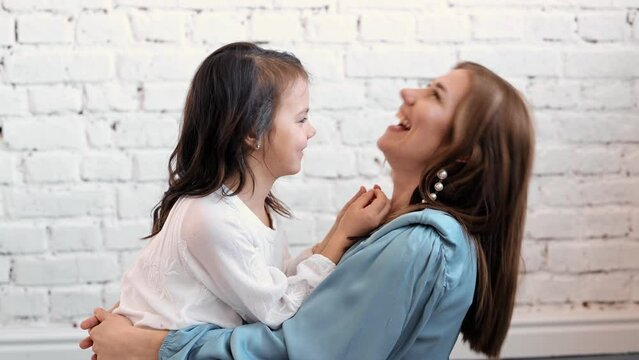 Happy cute affectionate adopted little kid girl hugging foster care parent mother with eyes closed, adorable small child daughter embrace mum cuddling enjoy tender sweet moment concept, close up view